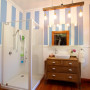 white bathroom, striped bathroom, oak vanity, blue and white paint, vintage bathroom