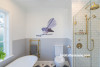 blue bathroom, kids bathroom, tongue and groove, resene, fantail decal, bath tub, brass tapware