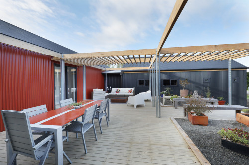 house exterior, deck, corrugated iron exterior, outdoor living, outdoor dining, red exterior