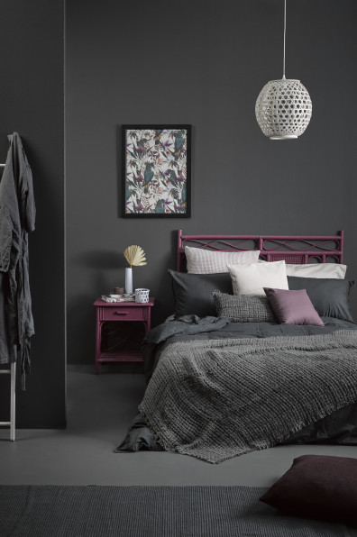 A sophisticated slate bedroom gets a tropical twist