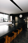 This striking black kitchen is the crown jewel of a contemporary North Otago farmstead