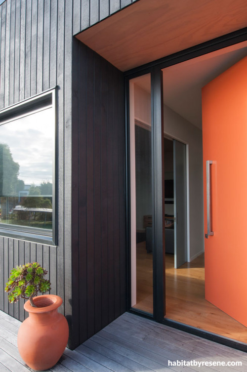 house exterior, black house, orange front door, black exterior, orange and black, black cladding 
