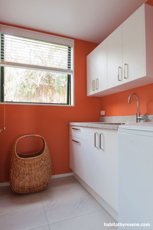 laundry, orange laundry, white cabinetry, white and orange, orange paint, orange interior