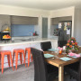 kitchen, dining room, blue splashback, orange chairs, white walls, resene double alabaster