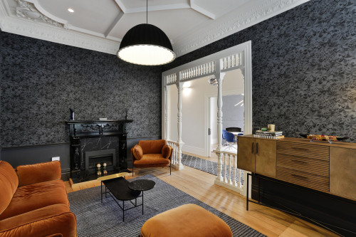 lounge, living room, wallpaper feature wall, grey wallpaper, grey and orange, grey lounge