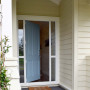 cream white exterior, blue door, resene bali hai, resene half pavlova, California bungalow style