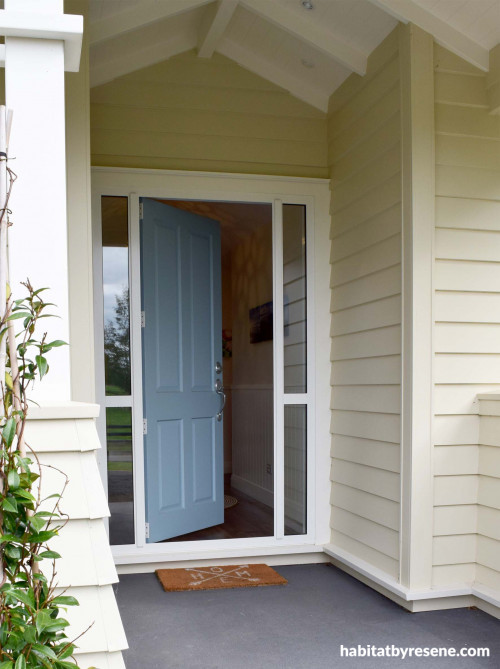 cream white exterior, blue door, resene bali hai, resene half pavlova, California bungalow style
