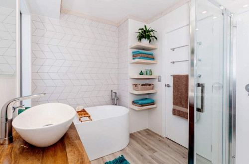 white bathroom, freestanding bath, geometric tiles, open shelving