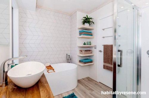 white bathroom, freestanding bath, geometric tiles, open shelving 