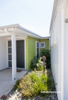 painted weatherboards, white house, green feature wall, green entranceway, house exterior