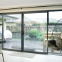 indoor outdoor flow, kitchen, living area, neutral dining room, deck, indoor hanging chair 