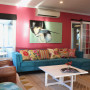 living room, lounge, pink lounge, pink feature wall, blue sofa, pink and blue, resene rouge
