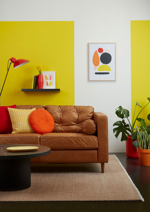lounge, living room, yellow lounge, yellow living room, leather couch, yellow feature wall