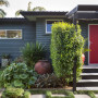 grey exterior, red front door, grey house, grey weatherboards, garden, entranceway 
