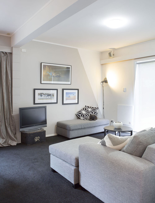 white living room, lounge, white paint, grey couch, dark carpet