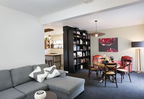 living room, lounge, dining room, black carpet, white paint, green feature wall, upcylcled bookshelf
