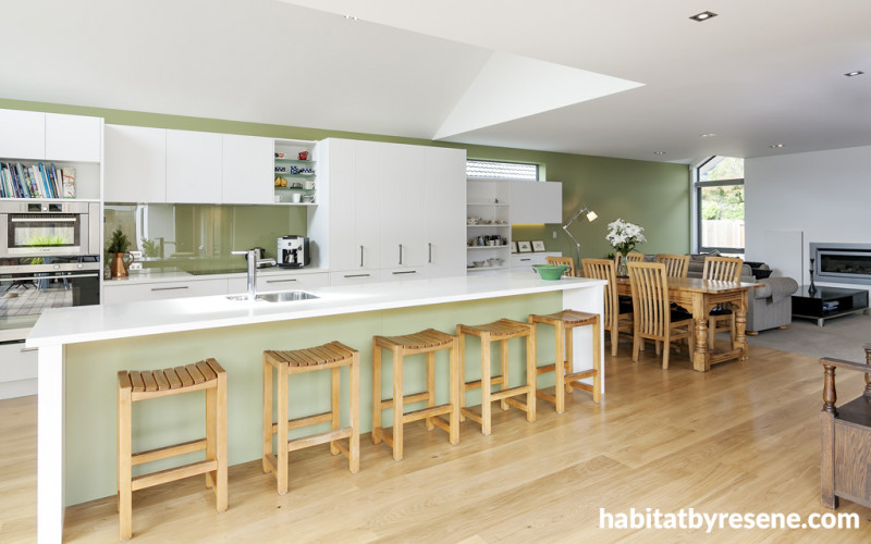 green kitchen, living area, wooden floors, green splashback, lounge, green and white paint