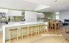 green kitchen, living area, wooden floors, green splashback, lounge, green and white paint