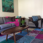 living room, lounge, neutrals, colourful accessories, colourful rug 