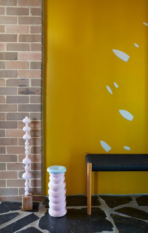 yellow feature wall, yellow interior, brick interior, flooring ideas, gold feature wall