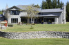 house exterior, grey house, grey exterior, lifestyle block, garden, stonewall 