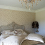 bedroom, master bedroom, patterned wallpaper, neutrals, feature wall, chandelier 