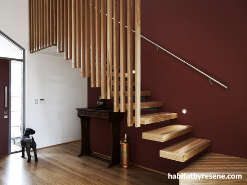 brown entranceway, wooden stairwell, brown painted wall, feature wall, interior