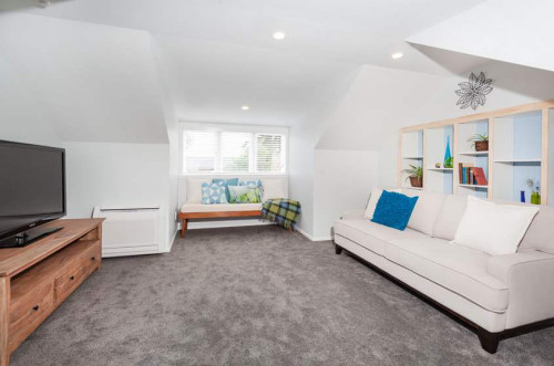 white living area, white lounge, white paint, custom shelving, blue paint