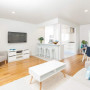 white kitchen, white living room, white lounge, white paint, blue furnishings, timber floorboards