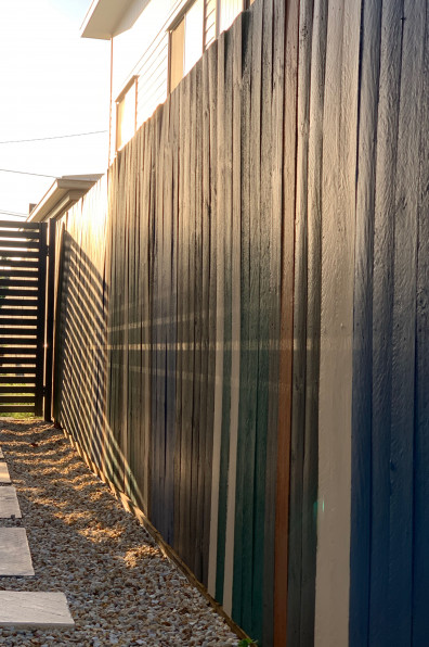 This artist’s Brisbane home is so colourful even the 85m fence is an elegant rainbow