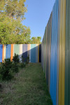 This artist’s Brisbane home is so colourful even the 85m fence is an elegant rainbow